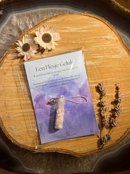 Rozenkwarts geluksflesje in zakje